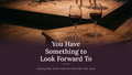 A moody photograph of two wine glasses filled with red wine on a wooden table, with overlaid text reading 'You Have Something to Look Forward To' and smaller text 'Dating After 30 for Women Who Like Their Lives'.